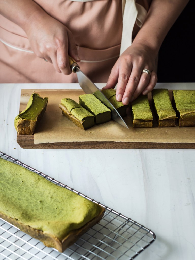 hands holding a knife to cut again each stripe into 1/3 or cube shapes